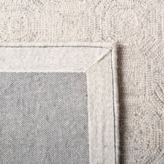 a close up view of the corner of a rug with an empty square on it