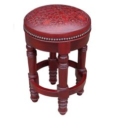 the stool is made from wood and has an intricate pattern on it's seat