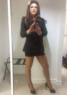 a woman standing in front of a mirror taking a selfie