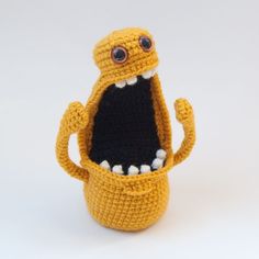 a small crocheted toy with an open mouth