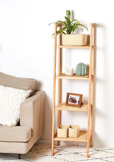 a living room with a couch, chair and shelving unit