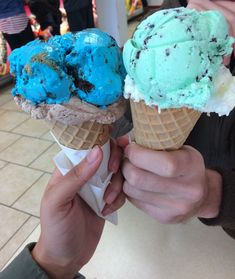 two ice cream cones with blue and green toppings