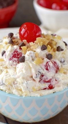 an ice cream sundae with chocolate chips and cherries on top, topped with a cherry