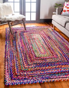 a living room with a couch, chair and rug