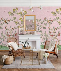 a living room with floral wallpaper and wicker chairs in front of a fireplace