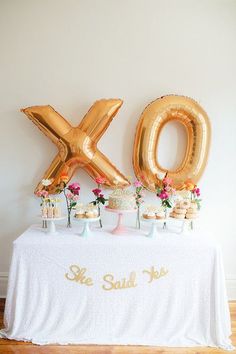 an image of a table with balloons and cake on it that says xoxo