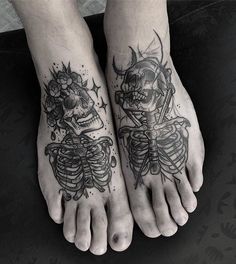 two people with tattoos on their feet and one has a skull in the shape of a heart