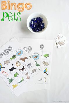 the printable animal matching game is next to some blue gummy candies and a white bowl