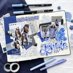 an open scrapbook with blue and white paper, scissors, and some other items