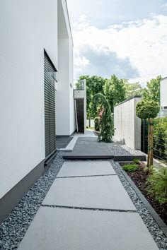 the walkway is lined with stones and gravel, leading to an outdoor area that has been designed