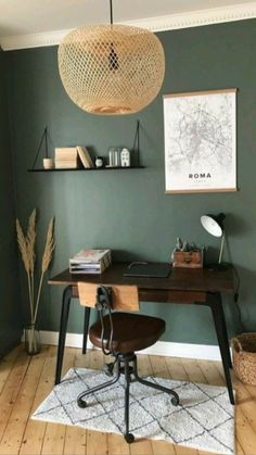 a room with a desk, chair and shelves on the wall in front of it