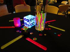 a black table topped with lots of different colored sticks