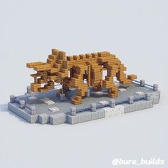 an animal made out of lego blocks sitting on top of a blocky platform in the snow