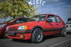 two red cars parked next to each other in a parking lot with the words music exchange on it