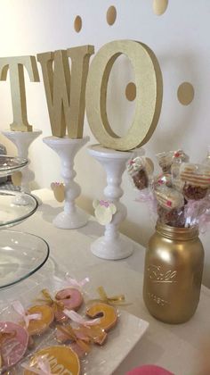 a table topped with lots of desserts and cookies