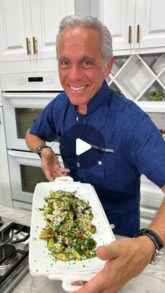 a man holding a white plate filled with food