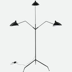 three light floor lamp with two lamps on each side and an electric cord connected to it