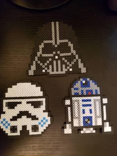 star wars perler bead patterns on a wooden table with the characters from legos