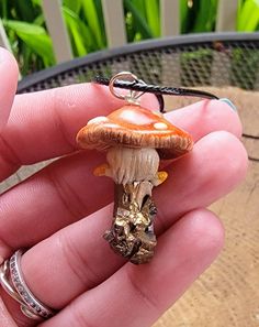 Fairies! Here is your dream necklace! A hand scuplted, gorgeously detailed mushroom growing from a real crystal shard! What can make this even better? It glows in the dark! Made from polymer clay and crystal shard then coated with an enamel gloss for durability and shine. This is water-resistant but I wouldn't recommend wearing it in water. Strung from an 18" black leather cord. All orders will be shipped within 3 business days of payment unless otherwise noted. In an effort to go green, I do no Clay Mushroom Pendant, Unique Adjustable Mushroom-shaped Jewelry, Fantasy Polymer Clay Jewelry As A Gift, Whimsical Copper Jewelry As Gift, Whimsical Bronze Jewelry For Gifts, Fantasy Copper Jewelry As Gift, Whimsical Brown Jewelry For Gifts, Whimsical Brown Jewelry Gift, Whimsical Brown Jewelry For Gift