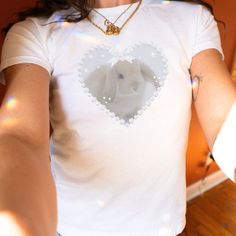 Fluffy bunny, so soft and delicate ʚɞ ♡ More of Coquette Aesthetic: https://www.etsy.com/shop/RainieshopDesign?ref=seller-platform-mcnav&section_id=1   PRODUCT DETAILS   ♡ Gildan Heavy Cotton™ Tee ♡ Made with 100% cotton ♡ Midweight fabric (5.3 oz/yd² (180 g/m ♡ Loose fit ♡ Sewn-in label ♡ Runs true to size  SIZING   ▸ Please refer to the last picture with size chart for sizes and product dimensions.  ▸ Be aware that these shirts are baby tees that can have a snug fit if you choose your normal size your smaller. If you prefer a more relaxed style or find a tight fit uncomfortable, you may want to consider selecting a size 1-2 sizes larger than your usual size. ▸ To find your best fit, take your favorite baby tee that you owned, lay it out flat and measure from armpit to armpit. Then, use t Cute White T-shirt With Bunny Design, Fitted White Kawaii T-shirt, White Fitted Kawaii T-shirt, Cute Bunny Design Short Sleeve T-shirt, Cute Short Sleeve T-shirt With Bunny Design, Cute Bunny Design T-shirt, Cute Crew Neck Top With Bunny Design, Cute Bunny Design Crew Neck T-shirt, Cute White Bunny Design T-shirt