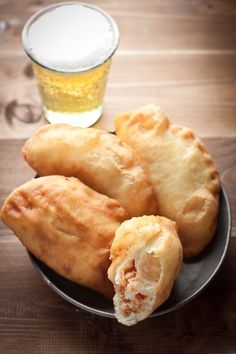 some fried food on a plate next to a beer