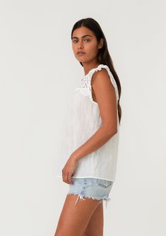 An ultra-pretty bohemian top with short cap sleeves and a sheer eyelet lace yoke detail. Cotton eyelet lace yoke Relaxed fit Short cap sleeve Ruffled neckline Split v-neckline Bohemian spring top Pretty eyelet lace details add a feminine touch to this effortless bohemian top. With short cap sleeves, a split v-neckline, and an easy relaxed fit. Perfect for spring, we love to pair this lightweight cotton top with denim and a simple sandal. Model is 5'9, wearing a size S.Style: I-15298W-SOH White Boho Tops, Gauze Top, Simple Sandals, Velvet Heart, Bohemian Tops, Graphic Sweaters, White Lace Top, Eyelet Lace, Spring Tops