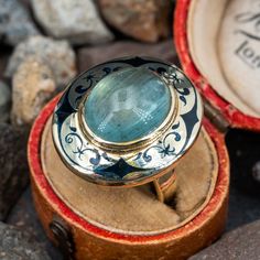 This amazing vintage cocktail ring is centered with an oval, aquamarine cabochon, weighing 7.05 carats, in a full bezel setting. The top of the ring is accented with black enamel details. The ring measures 23.5mm at the top, rises 10.0mm above the finger, tapering to 2.7mm wide and 0.8mm thick at the base of the shank. This ring is currently a size 5.5. Vintage Aquamarine Ring, Aquamarine Stone Ring, Antique Cocktail Ring, Aquamarine Ring Vintage, Aquamarine Solitaire Ring, Victorian Antiques, Antique Engagement Rings Sapphire, Estate Jewelry Rings, Queen Anne Victorian