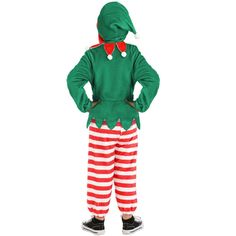 a little boy dressed up in a green and red striped suit with an elf hat