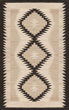 an old navajo rug with black and white designs on the front, brown border around it