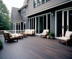 an outdoor deck with chairs and potted plants