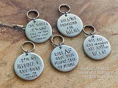 four metal key chains with sayings on them