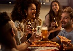 group of people eating pizza and drinking beer