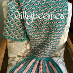 a crocheted blanket sitting on top of a chair