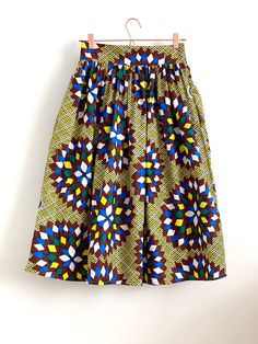 "Yellow and brown abstract print, African, full gathered skirt. Perfect for casual outfits and special ocasions with pair of trainters or high heels. 100% cotton.  Elastic at the back of waist.  Two side pockets. Midi length about  70cm  + 5 cm waistband. Handmade in UK.  HOW TO CHOOSE A SIZE ?   Using a measuring tape, measure the smallest part of your waist.  SIZE CHART: (CM) XS - W: 66 CM S - W: 70 CM M - W: 74 CM  L - W: 78 CM  XL - W: 82 CM  CARE INSTRUCTIONS: Hand wash only, do not bleach, hang dry, do not tumble dry, press with a cool iron on the reverse side.  Please message me before purchasing so I can check availability. If you wish this skirt in any other fabric, shorter or longer \"send message to seller\" and we can try to make something especially for you. *Depends on comput Fitted Brown Cotton Skirt, Brown Cotton Gathered Skirt Bottoms, Brown Cotton Bottoms With Gathered Skirt, Brown Cotton Gathered Skirt, Brown Cotton Full Skirt, Blue Printed Cotton Skirt, Blue Cotton Printed Skirt, Full Skirts, Made Clothing