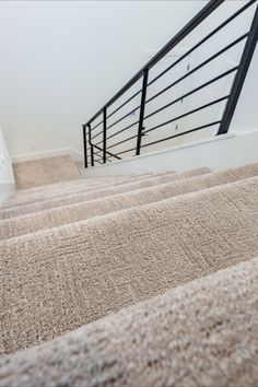 carpeted stairs leading up to the second floor