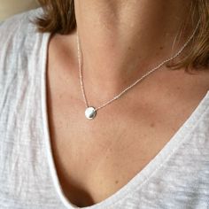 A pretty little minimalist and bright 925 silver necklace. o Size of the medallion: 1 cm. o Chain length: 40 to 45 cm (adjustable). Everything is in solid 925/1000 silver Made in France. Simple and light, this pretty little necklace in solid 925/1000 silver is easy to wear. Discreet and bright, it brings a touch of originality to your neck. It can be worn every day as well as to dress up a pretty evening dress. It can be worn alone or stacked with other necklaces from the same collection. It is suitable for all styles and all ages. The small medallion is on a silver chain which is adjustable from 40 to 45 cm. It's all solid 925 silver, so you can wash with it. It was created and handcrafted in my workshop in Paris. It comes packaged in a pretty fabric pouch. It is possible to add gift wrap