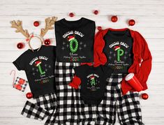 three matching christmas pajamas and onesuits with the number one on them, sitting next to decorations