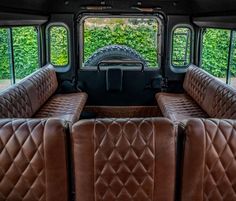 the inside of an old truck with leather seats in it's back end and windows