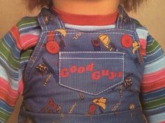 a doll wearing overalls with buttons on the front and back of it's chest