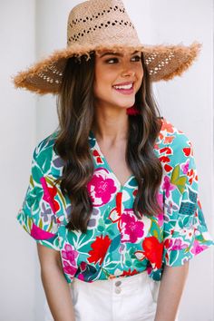 Look no further than this vibrant top if you want to fall wildly in love! Its bold floral print and vivid colors make it the perfect statement piece. This top features a v-neck, bold floral print, and short sleeves.  Material has no amount of stretch.Sydney is wearing the small. Green Floral Top, Wild Love, Bold Floral Print, Coral Flowers, Hair Appointment, Mint Julep Boutique, Bright Spring, Floral Print Blouses, Model Fits