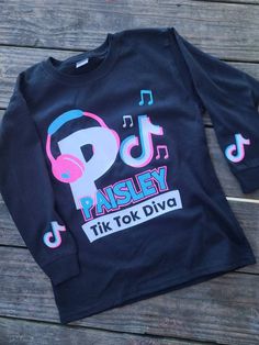 Do you, or do you know someone who LOVES Tiktok? Get them this cute custom Tiktok shirt! Available in long or short sleeve and youth or adult sizes. For YOUTH sizes see other listing. Please be sure to message name and custom text for shirt after ordering. Youth Shirt, Kids Graphic Tees, Adulting Shirts, A Child, Kids Tshirts, Gender Neutral, Graphic Tees, Kids Outfits, Adult Outfits