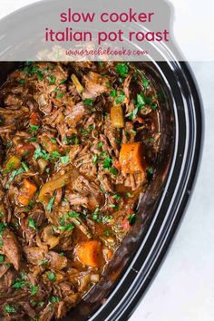 slow cooker beef stew with carrots and parsley in a black crock pot