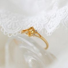 Kite Shape Citrine Dainty Gold Ring, Split Band Engagement Ring, November Birthstone Jewelry, Unique Crystal Rings, Citrine Rose Gold Ring DETAILS ♡⃛ ⃛ Main stone: Citrine Side stone: Moissanite Band width: 1.5mm Band thickness: 1.2mm OUR GEMSTONES ♡⃛ ⃛ At Kiseki Kiara, we use both precious and semi-precious stones throughout our jewelry designs, with each stone set-by-hand in our workshop. We carefully source gemstones for their quality and color ensuring you receive the best quality stones. Al Elegant Promise Birthstone Ring With Gemstone Accents, Dainty Wedding Birthstone Ring With Gemstone Accents, Gold Citrine Wedding Rings, Gold Yellow Sapphire Ring For Wedding, Elegant Diamond Flower Ring With Birthstone, Fine Jewelry Citrine Birthstone Promise Ring, Citrine Birthstone Promise Ring In Fine Jewelry, Citrine Rings With Gemstone Accents For Gift, Delicate Diamond Crystal Ring With Gemstone