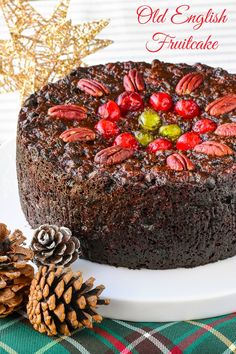 there is a chocolate cake with nuts on it and pine cones next to the cake