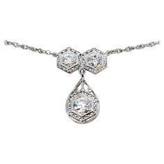 Incredible vintage diamond necklace bursting with Old World charm. This gorgeous piece boasts a simple yet elegant design, elevated by the intricate filigree detailing that really enhance the stunning Old European cut diamonds. This necklace is a true treasure. This beautiful drop necklace features 2 Old European cut natural diamonds (F-G in color, I1 in clarity) 6 prong set and arranged in hexagon shaped settings with delicate filigree borders. Dangling from the 2 stones is hinged teardrop shap Vintage Diamond Necklace, Diamond Drop Necklace, White Gold Set, Vintage European, Delicate Chain, European Cut Diamonds, Art Deco Diamond, Diamond Drops, Diamond Gold