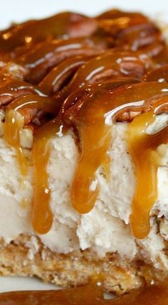 a piece of cheesecake covered in caramel and pecans