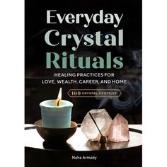 the book cover for everyday crystal rituals, featuring two candles and crystals on a table