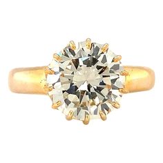 This magnificent 1960s engagement ring is a breathtaking blend of antique charm and timeless elegance, expertly crafted in 14K yellow gold. At its heart lies a dazzling 3.32-carat round brilliant-cut diamond, certified by GIA (Report No. 2211777954) with an O-P color and exceptional VS-1 clarity. The diamond's warm hue and stunning clarity radiate a captivating sparkle, making it the perfect centerpiece. The antique-style claw mount adds a touch of vintage sophistication, beautifully showcasing Vintage Yellow Gold Diamond Ring With Single Diamond, Vintage Yellow Gold Diamond Ring With Single Stone, Vintage Solitaire Diamond Ring In Yellow Gold, Antique Yellow Gold Diamond Ring With Vvs Clarity, Vintage Yellow Gold Diamond Ring With Diamond Cut, Vintage Yellow Gold Diamond Cut Diamond Ring, Classic Yellow Gold Cluster Ring With Single Diamond, Vintage Gold Diamond Ring With Brilliant Cut, Vintage Gold Diamond Ring With Vvs Clarity