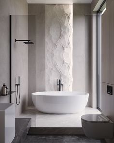 a large white bath tub sitting next to a toilet