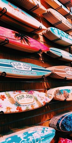 many surfboards are lined up on the wall